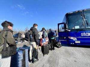 Students checking in to ride College Break Bus